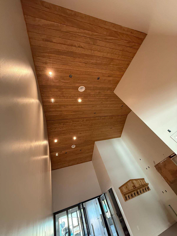 Modern residential interior with wood paneled ceiling