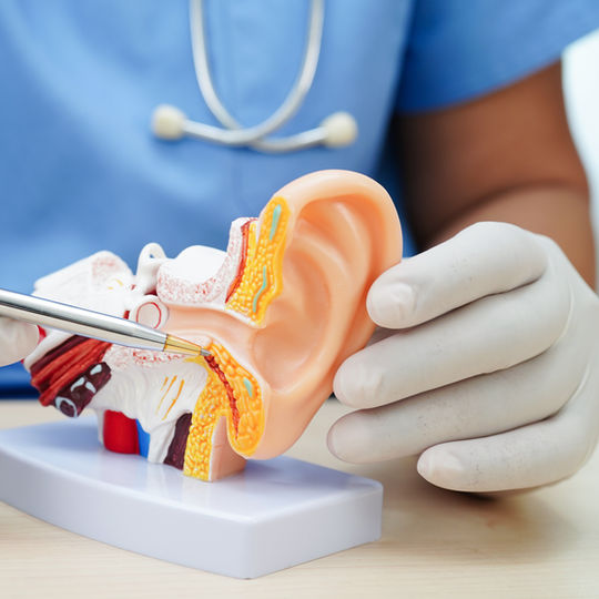 Woman holding her ear in pain