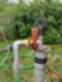 Small scale municipal well head with piping and hoses