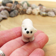 Tiny polar bear ornament on a hand