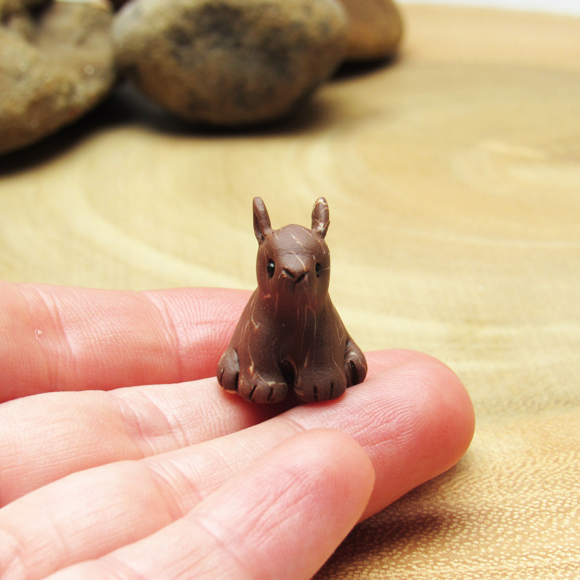 Tiny leveret ornament on a hand