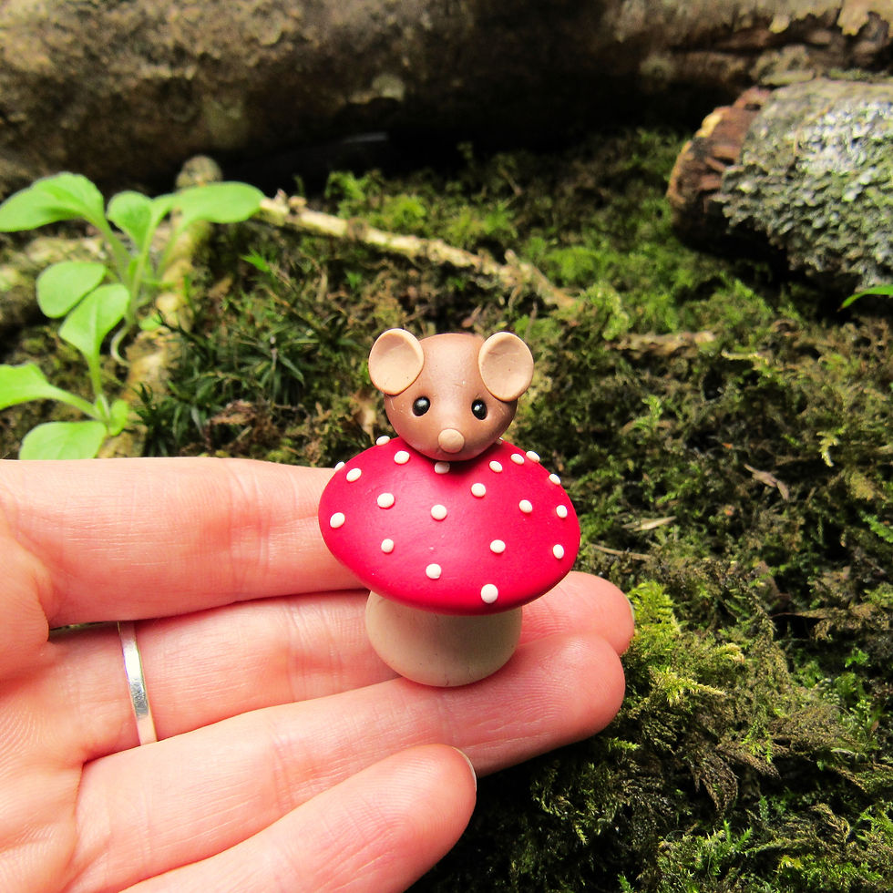 Tiny polymer clay mouse on a fly agaric mushroom