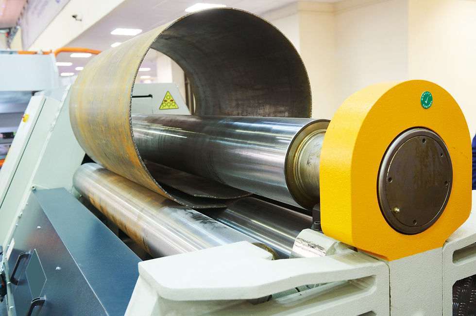 A large industrial metal rolling and bending machine shaping a steel pipe for aerospace and automotive applications.