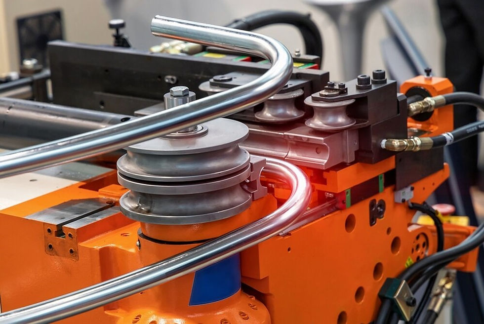 Rotary draw pipe bending machine creating a tight, precision curve in a shiny metal pipe.