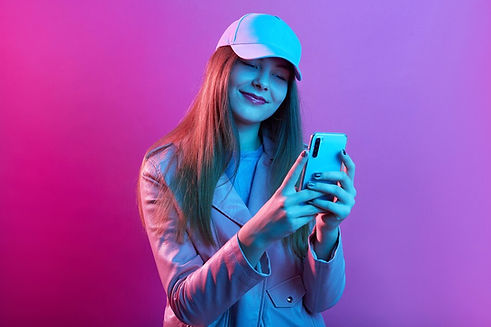 portrait-young-beautiful-fashionable-model-wearing-leather-baker-baseball-cap-holding-smar