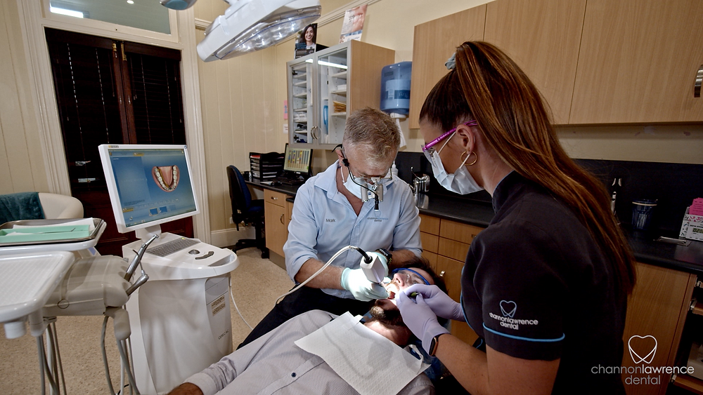 Dr Mark Cull, Gympie Dentist helping a patient with a toothache. What To Do When You have a Toothache.