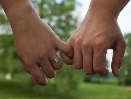 Engaged couple holding hands 