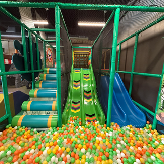 colorful ball pit, slides, and indoor play at little explorers