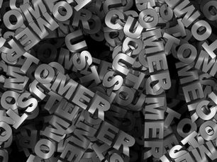 Black background with the word ‘customer’ graffitied repeatedly in different directions.