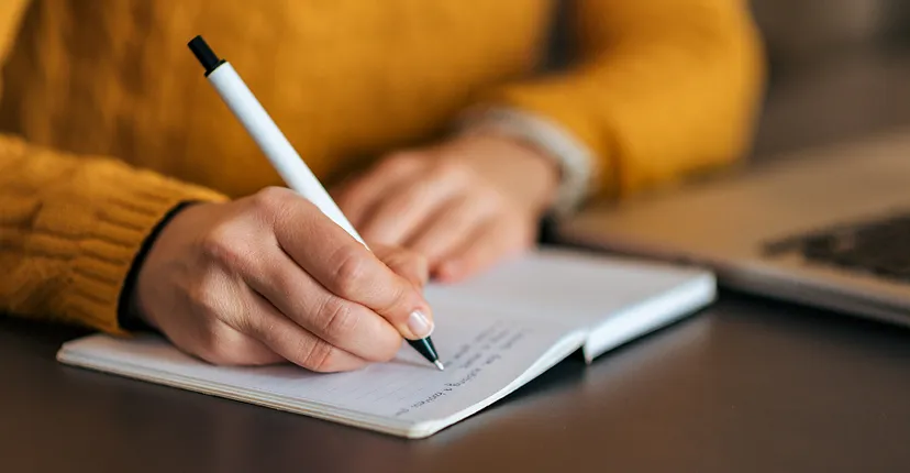 Women holding a pen and writing
