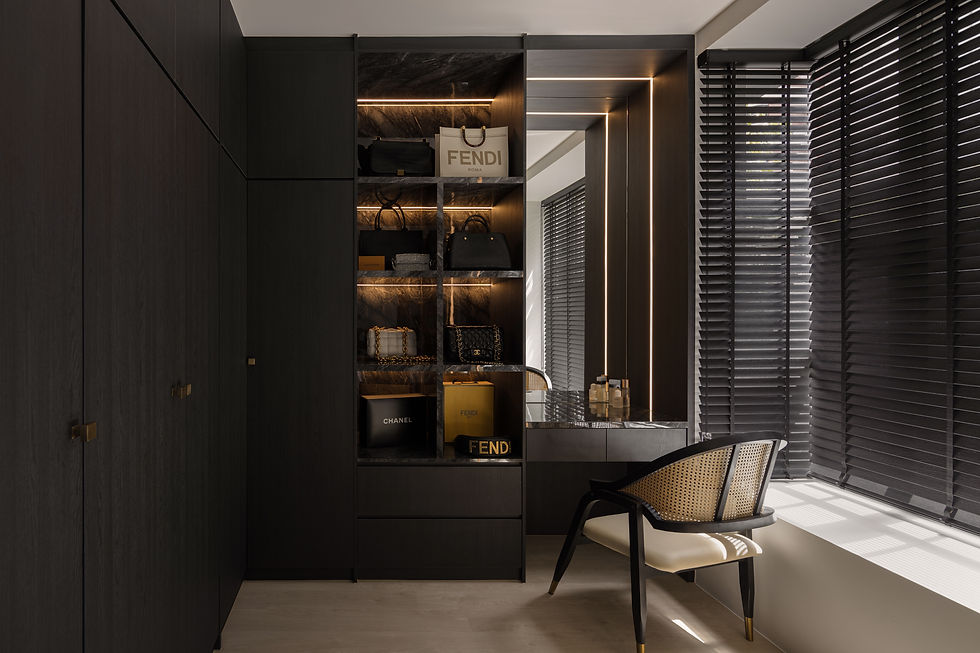 Luxury walk-in closet with dark wood shelves displaying designer bags and boxes. A chair and striped blinds add elegance to the setting.
