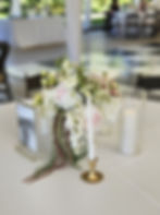 Smooth white flameless pillar candle glowing on table Utah wedding rental