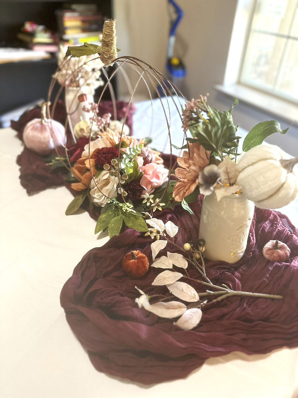 Thumbnail: Ivory Blessed Ceramic lantern with pumpkins, cheesecloth table runner and florals for baby shower in Utah