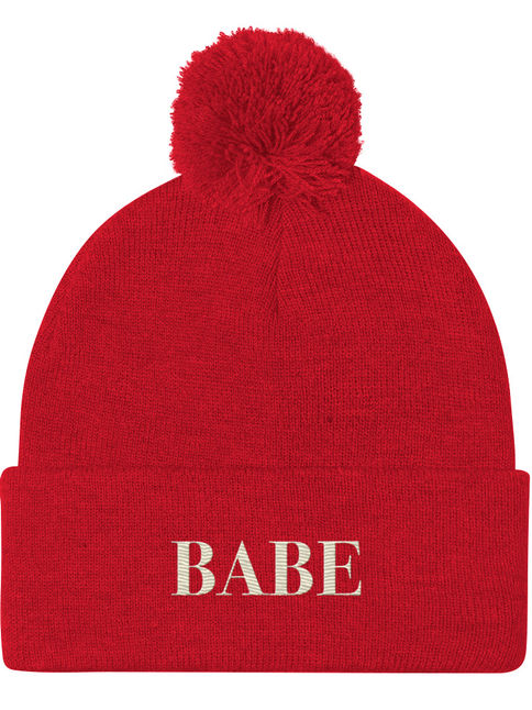 Pom-pom beanie embroidered with the word ‘Babe.’ Cute winter accessory.