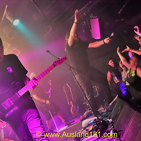 With electric energy crackling in the heat, set in motion by the preceding acts, Electric State hit the stage running hot. 
Vocalist/guitarist/megaphone user/interviewer/crowd conductor Rob amped up the Amplifier gathering who were already rippling with eager anticipation.
Kicking off with “Get In You” they stuck the rock sock down your throat and ran “Riot” with the next number. 
Launching their primal opus “Green Machine” the #greenmachine himself (Bill) hammered into the “Government” and keep driving the pace throughout the set.
Russ (guitar) and Paul (bass) gave us all a lesson on burning fretwork. Rob was out the blocks earlier, as his dynamic spirit dictates, and went on the “Run” into the packed gathering. 
One-on-one interviews are one element of his performance chemistry  and for once I was not to escape the mad scientist. 
When asked what I thought of it so far all I could bellow, dropping several semitones, and letting it rip like rock falls on A Flat Minor in a Tasmanian pit, was “Light It Up”.  
And “Light It Up” they did as the musical maestros didn’t miss a beat with the out of tune roaring. They keep Rob on track as he went off track just like a “FMH” (F@$king Mad Hoor - my interpretation).
It was a rock dog audience community affair with Janice the megaphone and her sisters coming out while helpless members got dragged up on stage. In fact the invited audience performers were a “Mirror” of the band themselves. 
Sharing is caring and even the cowbell bell duties were shared by the active participants at this love in gig. 
With the dedicated following belting the songs out verbatim in choreatic, choir like terms the anthemic quality of the hard rocking songs rung true. The best being “We’re Just Blood”, as well as the William Wallace freedom song, “Fed By The Algorithm”.
The set list was in fact the running order of the “Green Machine” itself. And while I may have rearranged the order slightly the trick is buying a CD, or doing the Dirty Download, and finding out where I went wrong. 
The prize will be a request to attend the next gig. Of which this hard working band have already penned in a next date (25th Feb, Lynotts Lounge).
This was an EPIC set so all that was left was to stare into “Tomorrows Sun”. 
In a year of uncertainty one thing is certain in 2022. At close of business  on 31st December this blockbuster extravaganza of a hard rock release will be one of THE Rock Releases of the year. 
#greenmachine #seeyounextgig