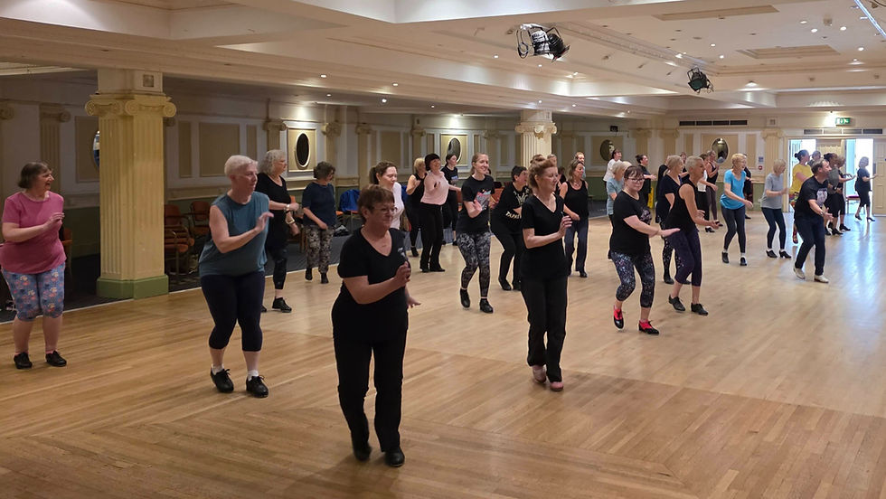 A large group of adult dancers taking part in Lee Farrow’s workshop at TapUK 2026.