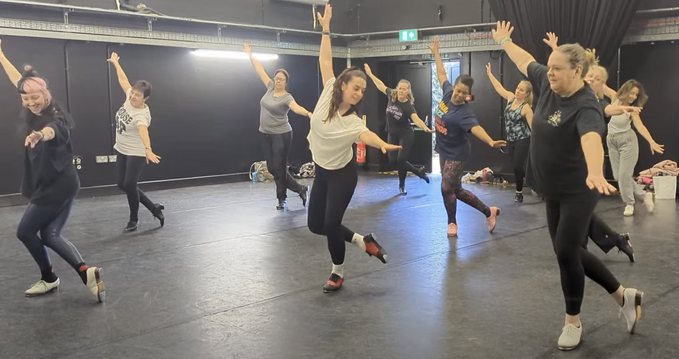 Dancers tap dancing in a studio