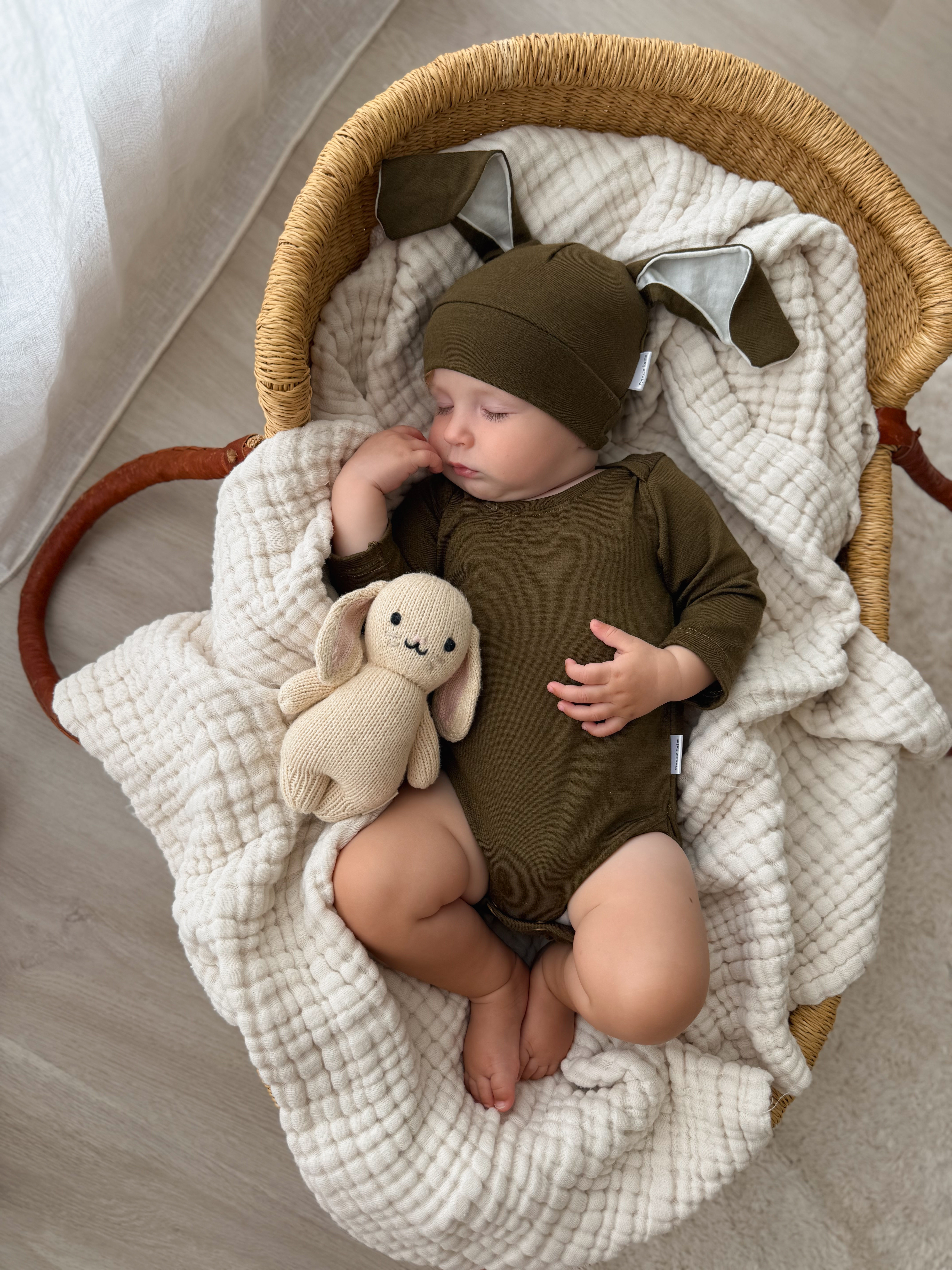 Baby wearing Army merino baby bunny hat and bodysuit