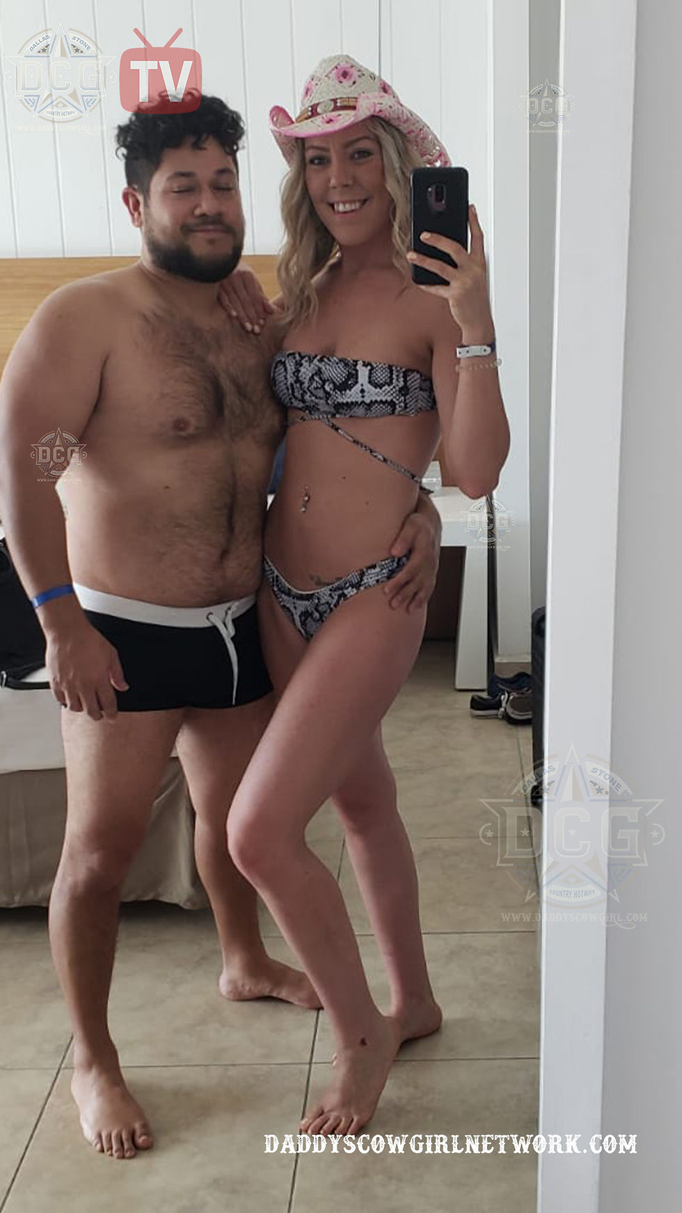 Dallas and Carlos taking a mirror selfie together while on vacation