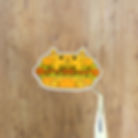 a sticker of a burger with a cat as the bun