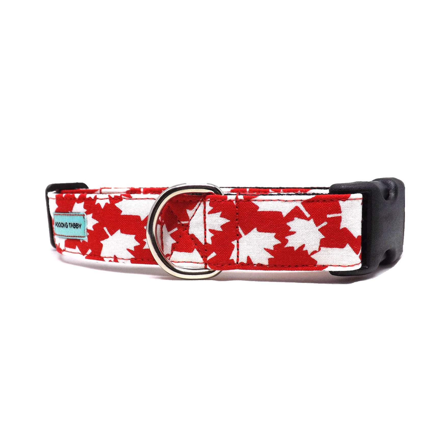 dog collar with white maples leaves tossed on a bright red background, front view