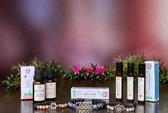 Australian Essential Oils products, including blends and diffuser oils with beaded gemstone jewelry on display.