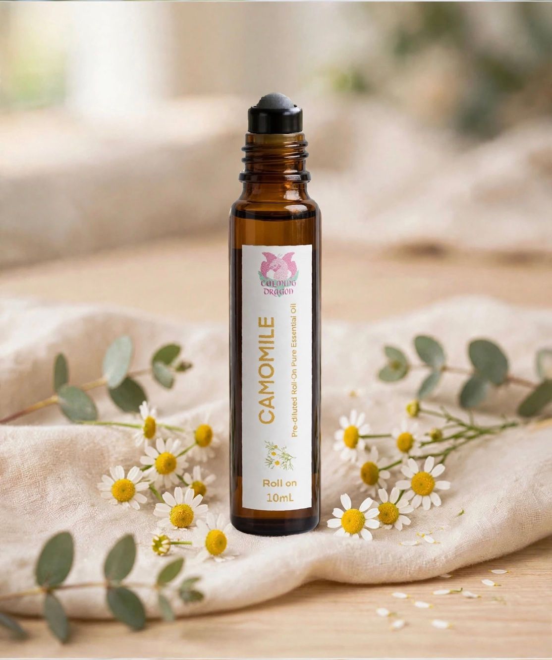 Chamomile essential oil roll on styled with chamomile flowers