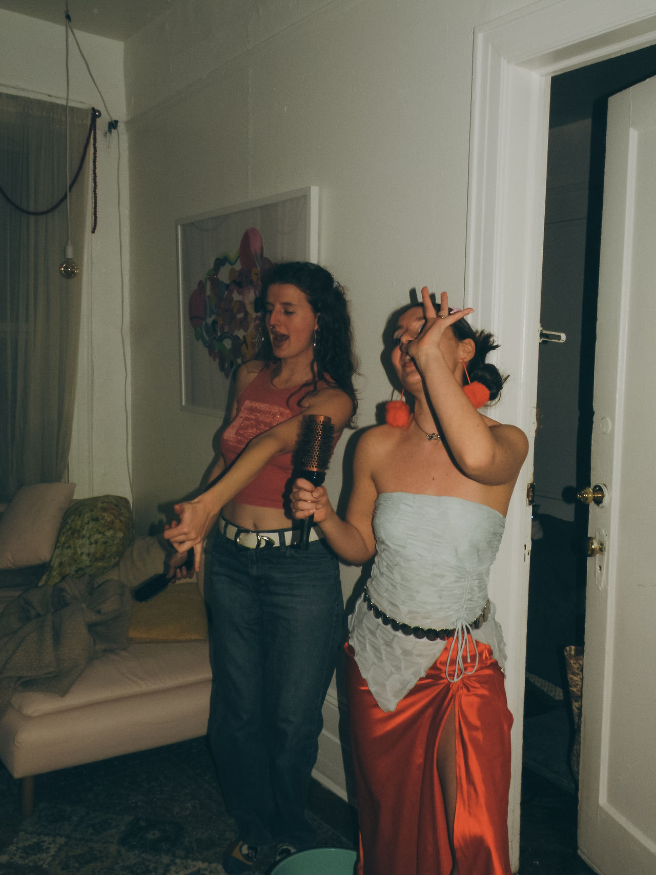 girls singing karaoke with a hairbrush