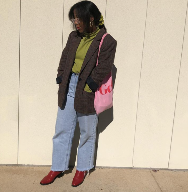 Kaitlin Harris wearing a green turtleneck and brown blazer outfit