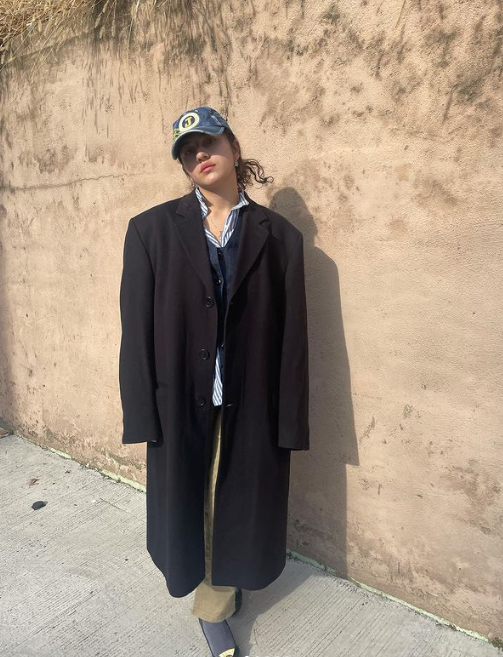 DENYEEZY in a black maxi coat and baseball cap
