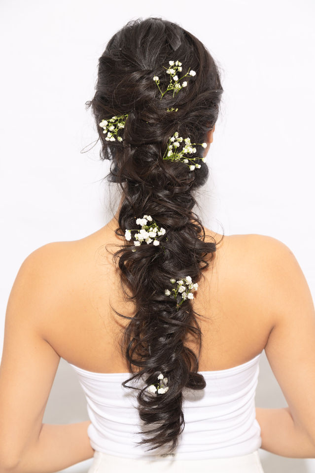 Woman's dark braided hair with white flowers on white background Meadowvale mississauga Hair salon Davines