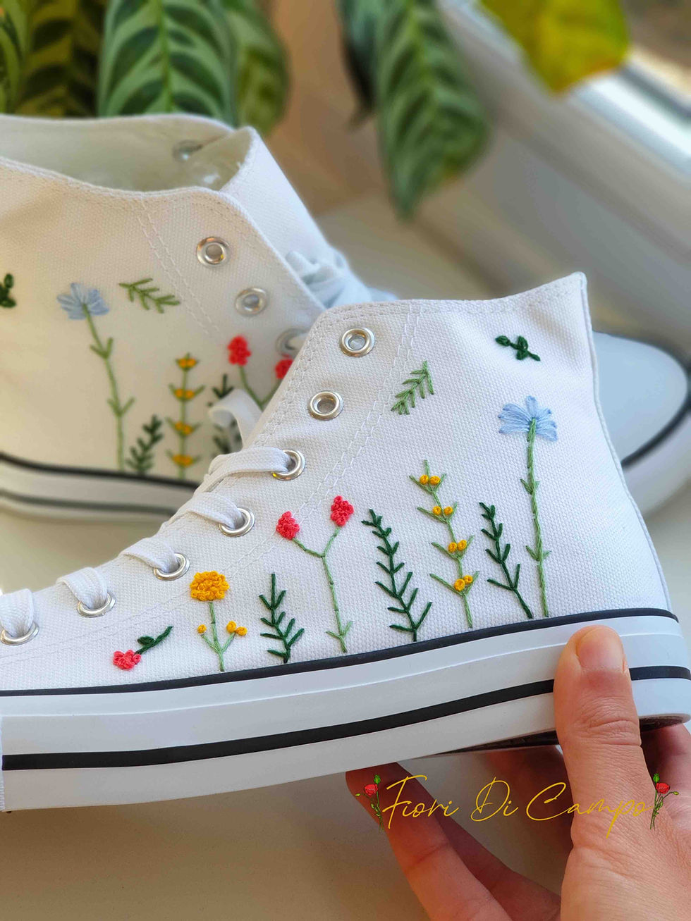 Thumbnail: White high-top canvas shoes with embroidered wildflowers, facing left.