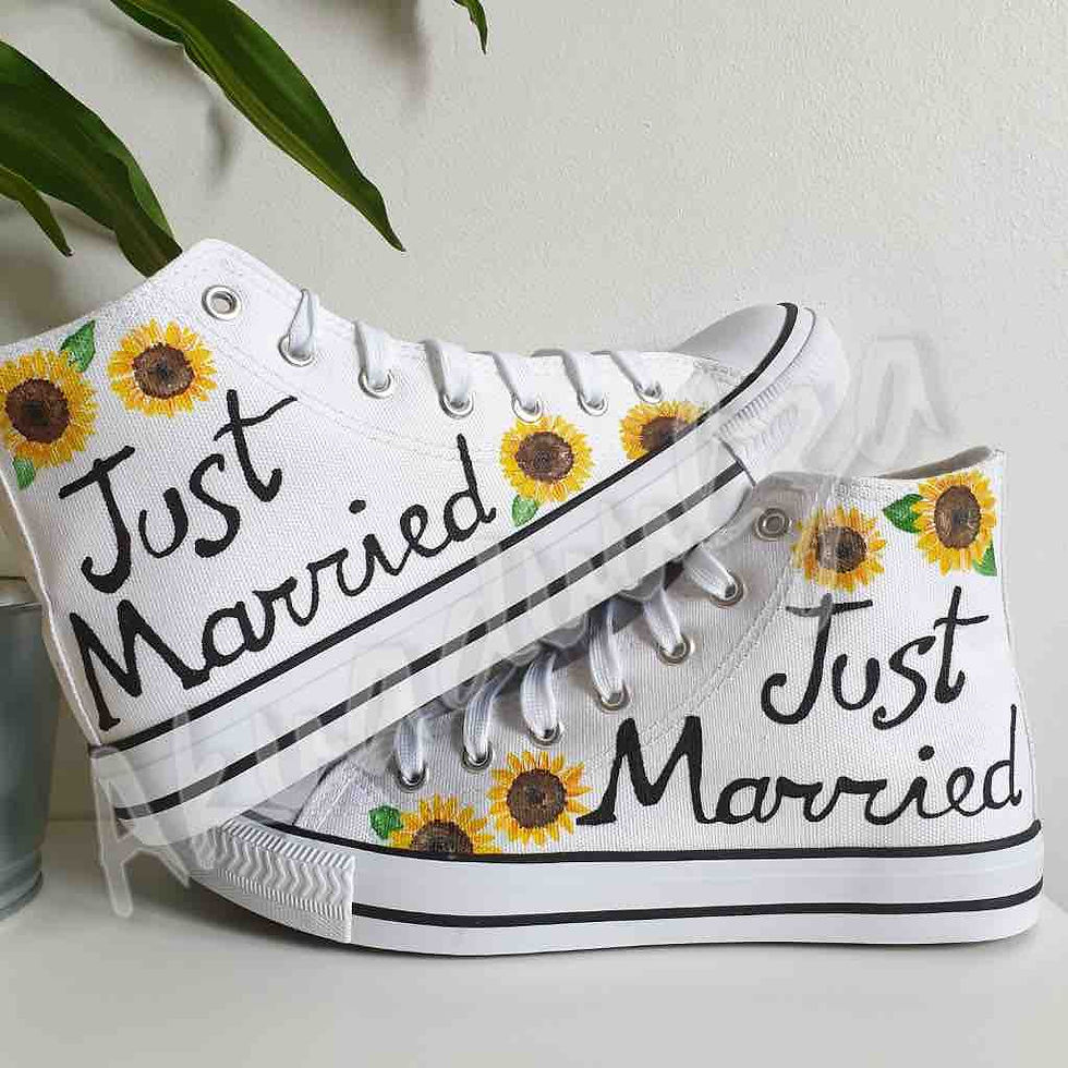 White high-top canvas shoes with handpainted 'just married' and sunflower, placed top of each other.