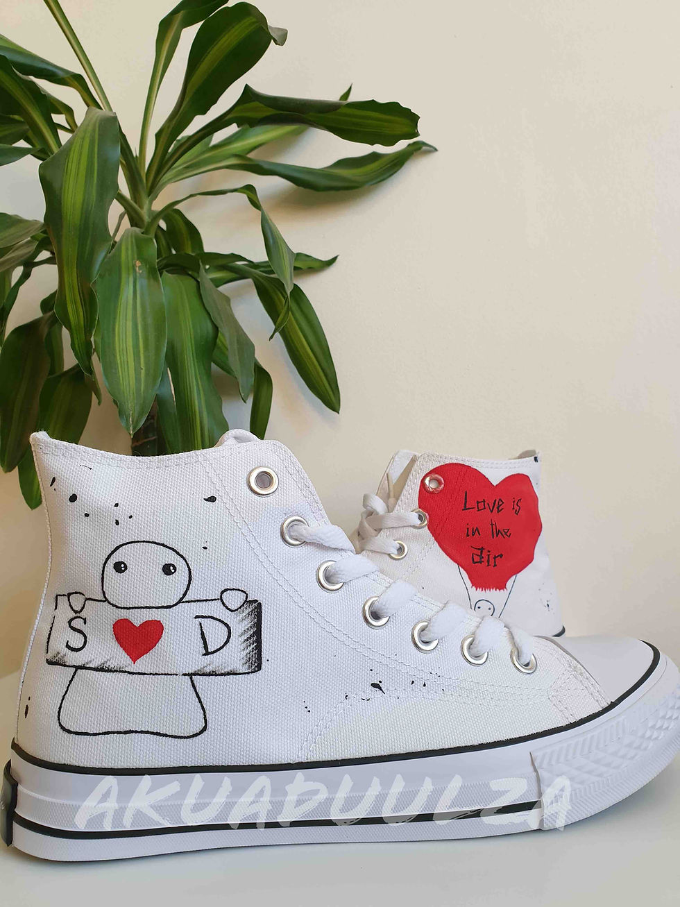 Thumbnail: White high-top canvas shoes with handpainted personalized heart, facing right.