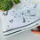 Thumbnail: White high-top canvas shoes with handpainted leaves, facing right.