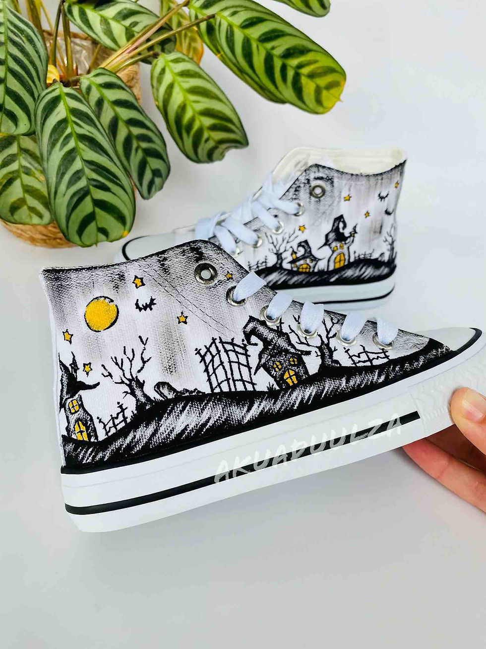 Thumbnail: White high-top canvas shoes with handpainted spooky Halloween haunted house scene, facing right.
