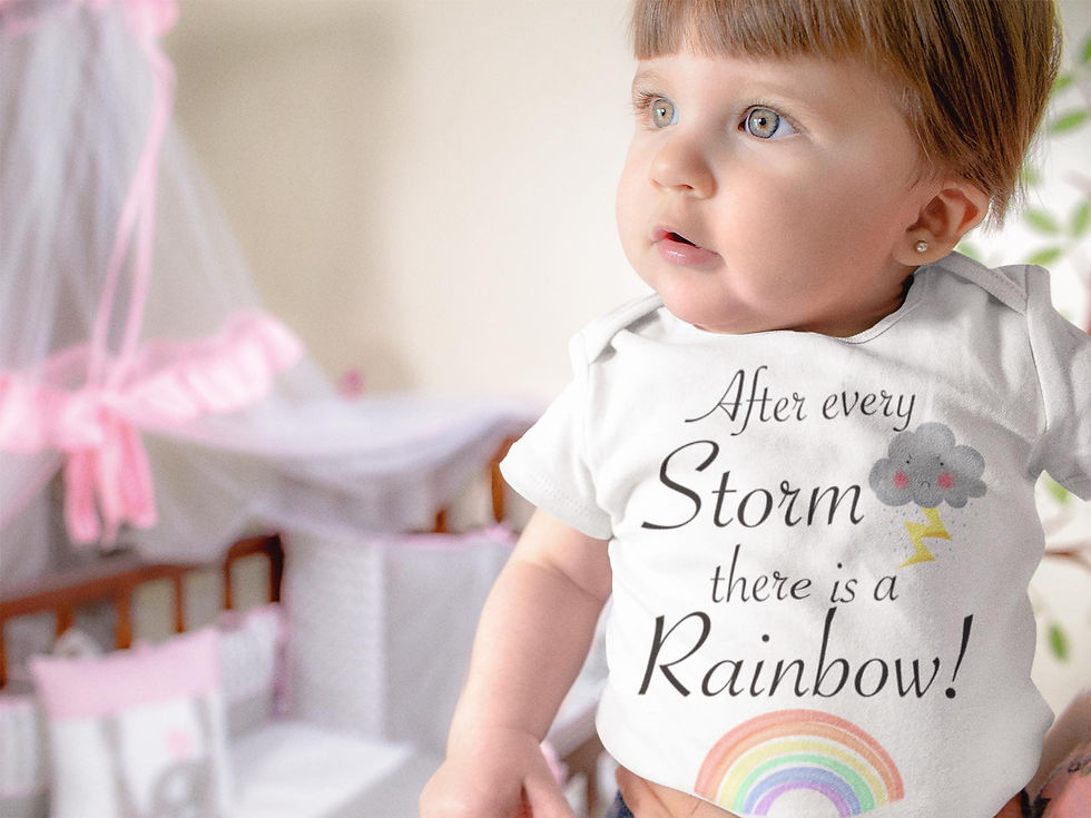 Baby with blue eyes wearing white bodysuit: "After every Storm there is a Rainbow."