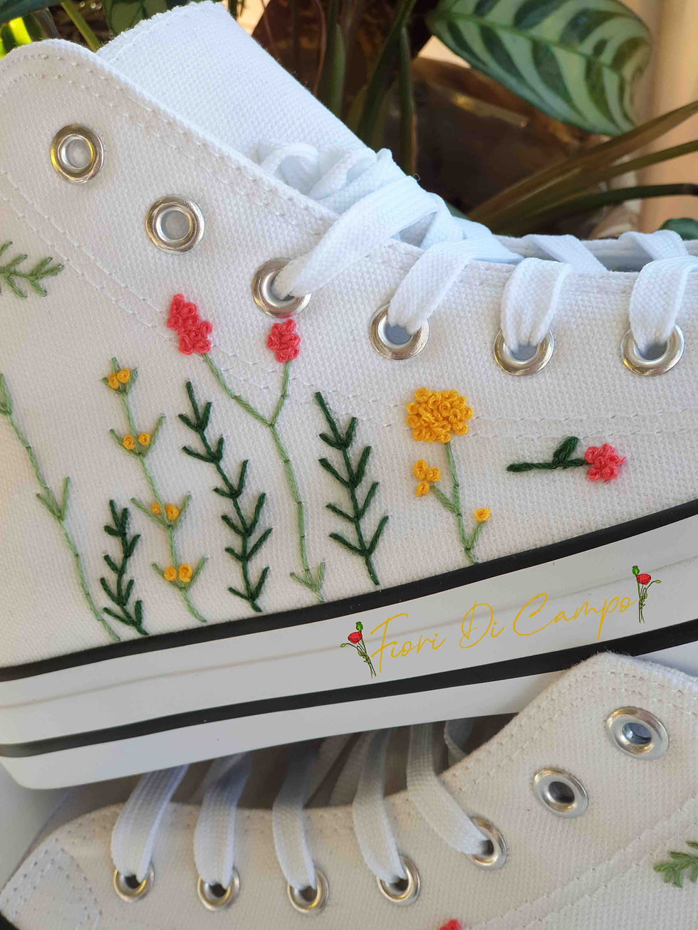 Thumbnail: White high-top canvas shoes with embroidered wildflowers, facing right.