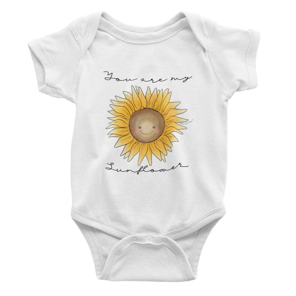 White baby bodysuit with "Sunflower", laid flat.