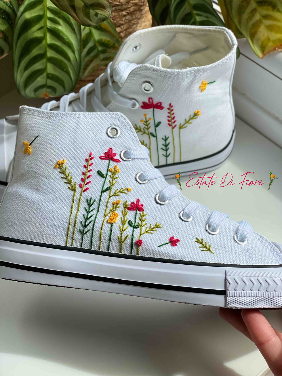 Thumbnail: White high-top canvas shoes with embroidered flowers, facing right.