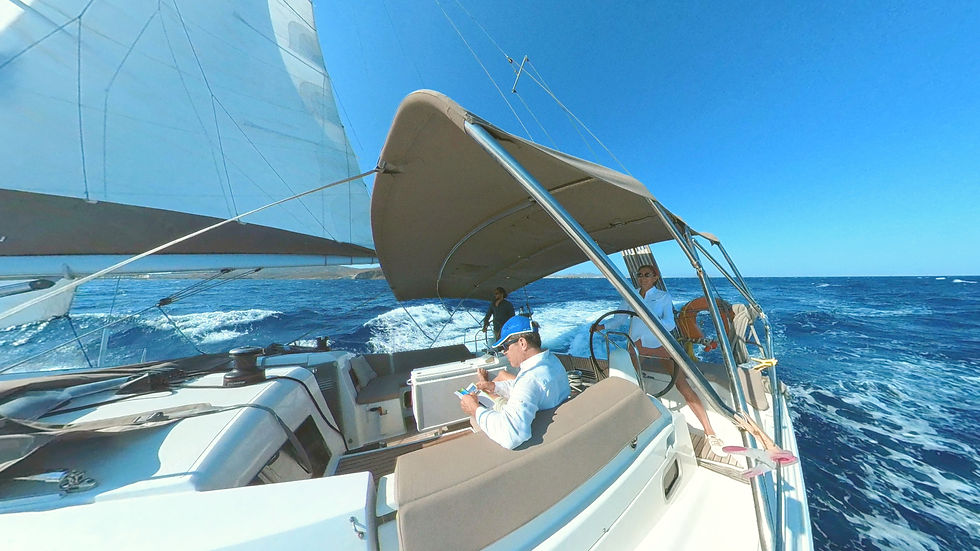 Sailboat on open water. Bright sun, blue sea, and white sails in an Epic Voyage experience by Sailing Flavors.
