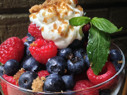 Berries in a bowl with mint sprig