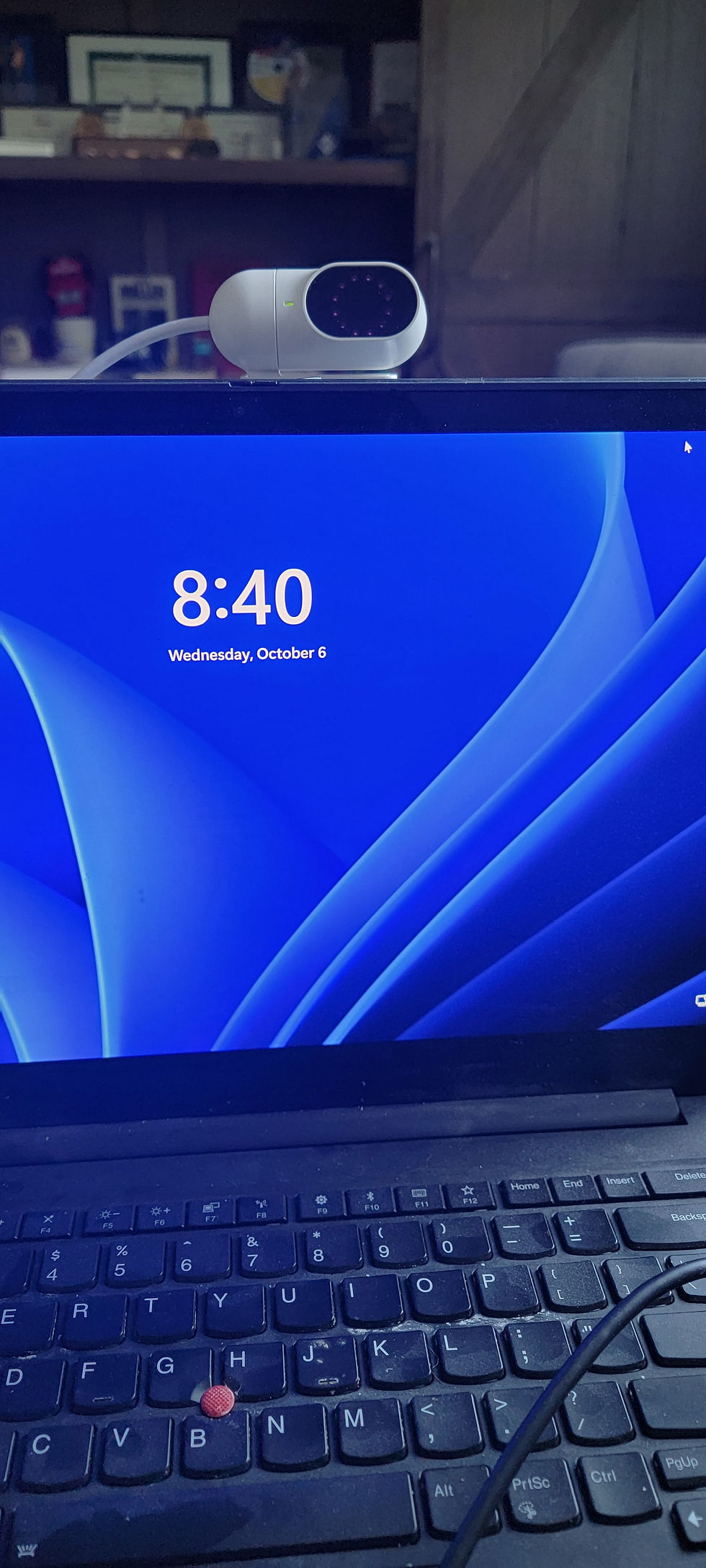 A device mounted behind a laptop screen