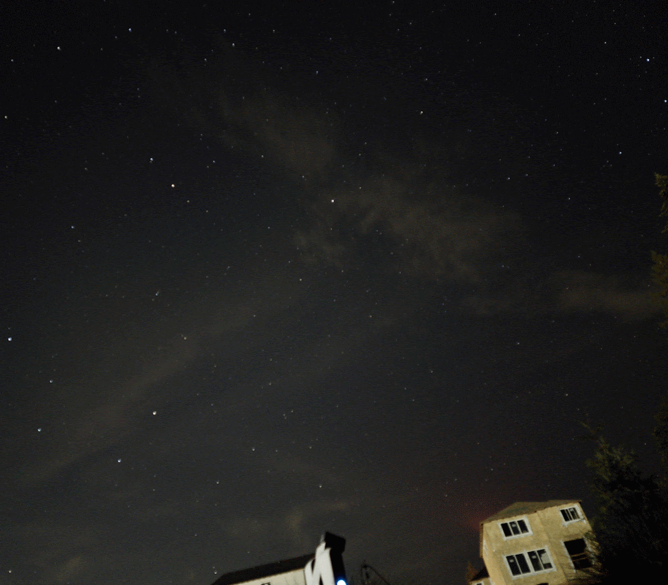 Clouds moving over stars in the night sky