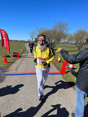 Runners crossing the finish line at the Act Now Foundation 5K Walk & Run