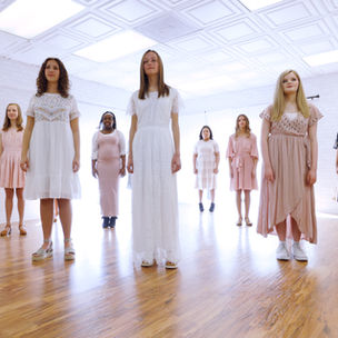 Young Women singing together in a bright room