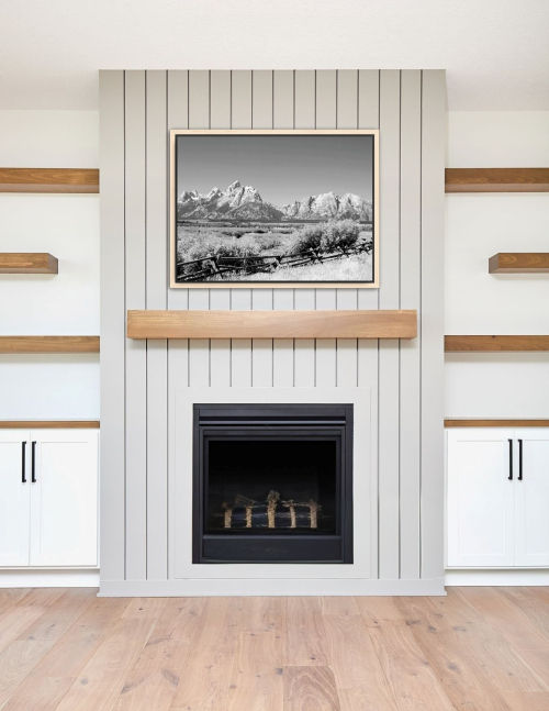 Thumbnail: Black and white landscape featuring the rugged Teton mountains and a rustic fence under a cloudless sky, over a fireplace