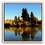 Thumbnail: Golden autumn trees and tall evergreens reflected in a calm river beneath a clear blue sky, set in a natural wood frame