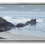 Thumbnail: Oil-like image of waves crashing on rocky shore under a cloudy sky, in muted tones of grey, tan and blue, in a silver frame