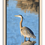 Thumbnail: A blue heron stands in tranquil blue waters, its graceful reflection shimmering beneath, set in a natural wood frame